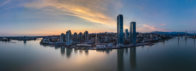 Fototapeta premium Modern City by river at sunset twilight. New Westminster, Vancouver, BC, Canada.
