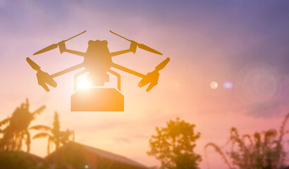 A silhouette shipping drone on sunset background