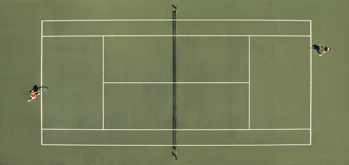 Aerial top view of a tennis match on a hardcourt field with players in action