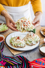mexican tostadas with chicken, woman cooking traditional homemade food in Mexico Latin America	