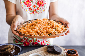 Mexican woman cooking rice with ingredients, traditional food in Mexico Latin America	