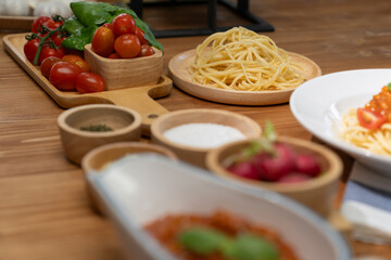 Delicious food's special menu homemade preparing station spaghetti with minced meat top tomato sauce and basil shooting placing elements serving with chef table surround decorative spices. Postulate.