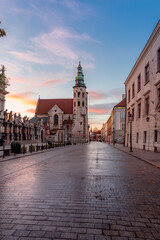 Fototapeta premium Krakow old town, romanesque St Andrew church on Grodzka street during colorful sunrise