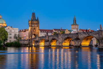 Charles Bridge (Karlův most) over Vltava river, illuminated in the evening, Prague, Czech Republic