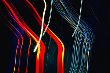 The image is a colorful abstract of light and dark lines. The colors are red, blue, and yellow, and the lines are wavy and curvy. Scene is energetic and dynamic, with the lines