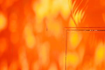 The orange wall has a shadow on it