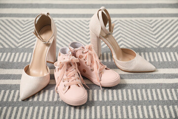 Naklejka premium Big and small shoes on carpet indoors