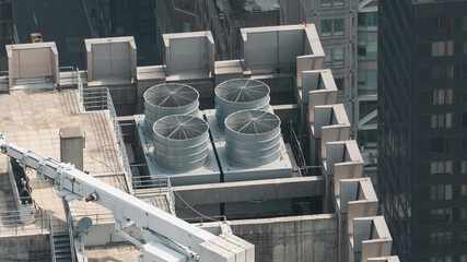 A large industrial building with a large cooling tower on top