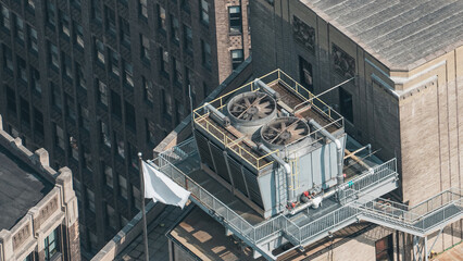 A large industrial building with a large cooling tower on top