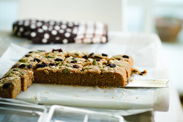 banana bread. this banana bread is homemade, i used brown sugar, flour, egg and also rile bananas. the top of the bread is almond slices, raisin, nuts and oat. the taste is so good and sweet.
