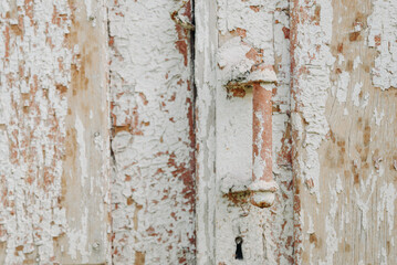 old vintage wooden door with rusty metal door handle