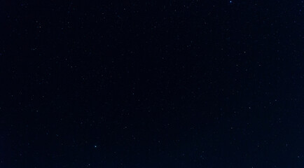 milky way and star on dark background.Universe filled with stars, nebula and galaxy with noise and grain.Photo by long exposure and select white balance.Dark night sky.