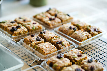 A bar of oat flakes, with bananas, nuts, dried fruits and honey in box. Healthy food.
