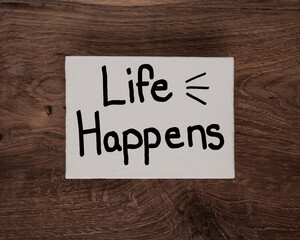 Life Happens hand written on white board lay flat background. 