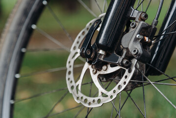 Bicycle wheel on grass, bicycle gear, disc brake pads, mountain bike wheel closeup,