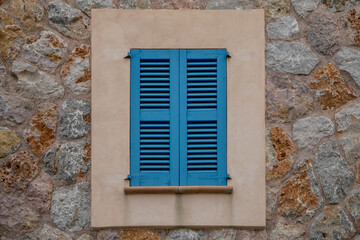 blue window sheds that are closed to keep the sun out, southern qurope