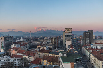 Ljubljana, Slovenia: view over the city with snow covered mountains in the background