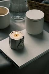 handmade scented candles stand on a book
