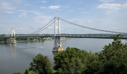 view of the mid hudson bridge to poughkeepsie, new york from highland (suspension bridge over river crossing) scenic landmark (pedestian and bike path, car lanes highway) valley ny state detail
