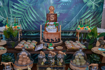 Birthday buffet with jungle theme. birthday cake and macaron