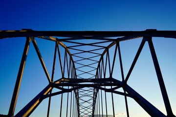 Steel girder structure of the old Omsund Bridge against the blue sky in Kristiansund, Norway