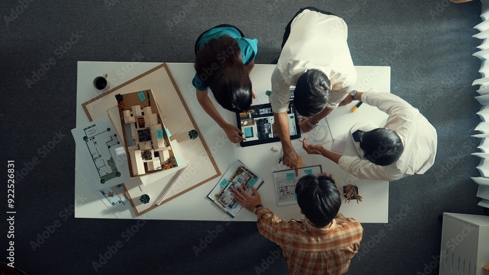 Poster top down view of architect engineer team discussing and point at tablet display construction at tabl