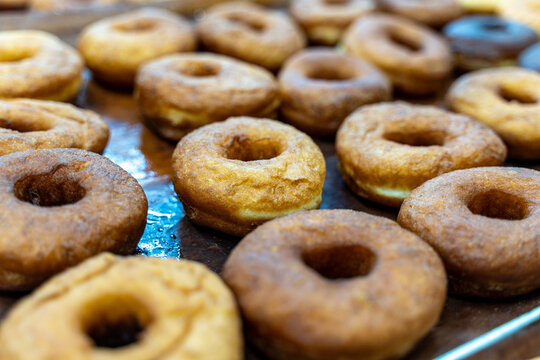 Close-up of donuts on a baking sheet. Donut production. Selected focus.
