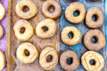 Close-up of donuts on a baking sheet. Donut production. Selected focus.