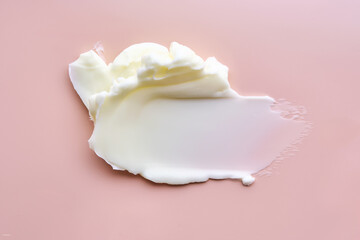 Texture of cosmetic butter on a pink background. Showcasing a thick and nourishing texture.