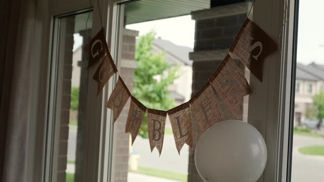 God Bless banner hanging in window of Christian household - Powered by Adobe