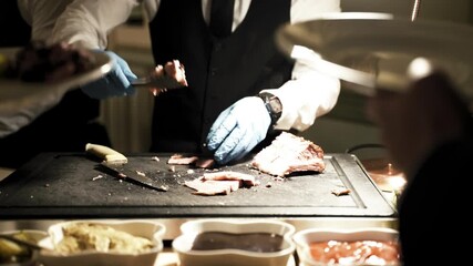 A chef in a commercial kitchen precisely slices a piece of meat, showcasing culinary expertise. The image highlights the detailed preparation process perfect for restaurant or cooking-related content.