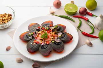 Spicy century Egg Salad,Preserved Eggs in chilli lime sauce with pickled ginger in white plate