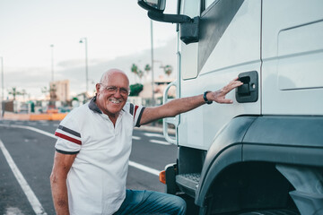 Senior truck driver prepares to climb into the cab of his truck. Concept of transport and deliveries by large vehicles