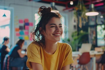 Happy young Hispanic female Designing user experiences and interfaces in startup company office