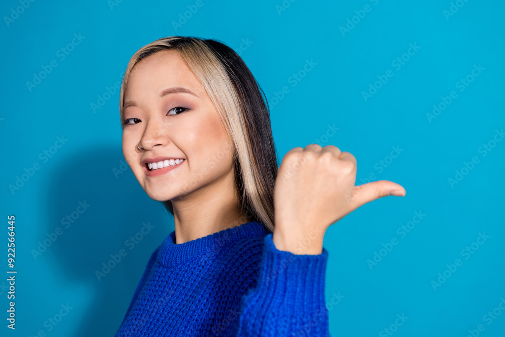 Wall mural photo portrait of lovely young lady point empty space dressed stylish knitwear garment isolated on b