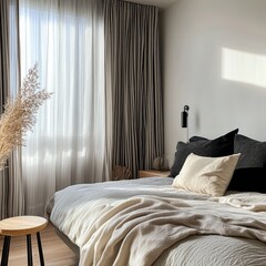 A minimalist bedroom featuring black and white striped curtains, a simple bed, and stylish decor