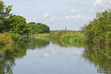 Countryside  viewed from narrowboat on the Chichester Canal in West sussex, England. Famous view painted by Turner of the Cathedral.