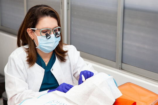 Dermatologist carrying out a skin biopsy on the face of a senior adult patient