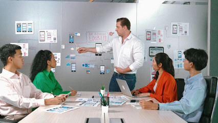 Group of professional business people discuss about using Ux and Ui design. Cooperative diverse business team brainstorming about marketing plan. Business people working together. Manipulator.