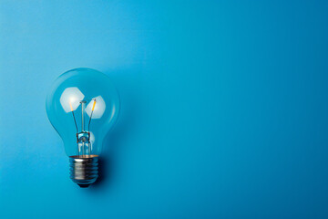 Light Bulb on Blue Background - Simple and Bright Idea Symbolizing Innovation, Creativity, and Inspiration