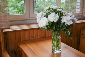 Blurred floral background. A bouquet of white peonies.