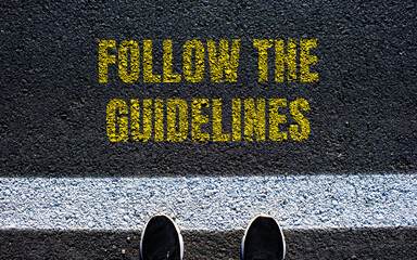 Follow the guidelines message written on asphalt road. Conceptual follow the guidelines symbol....
