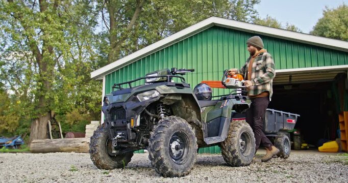 Young Man Walking Up To ATV With Tool