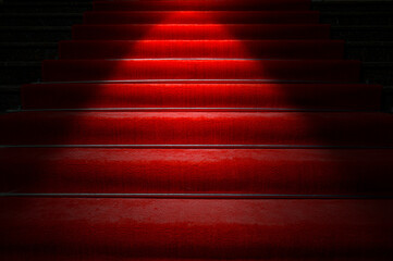 Red carpet on stairs and spotlight with light