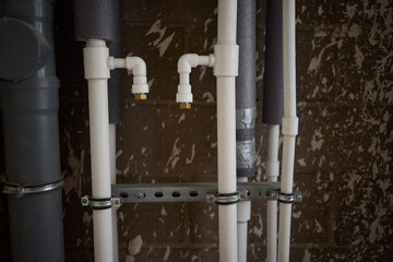 Overview of Industrial Pipes and Insulation prominently featured in a Basement Setting