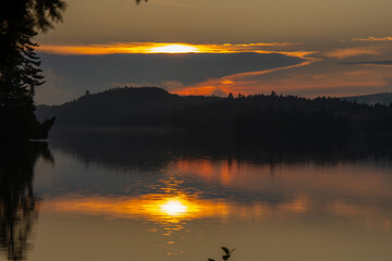 Fototapeta premium Sunset over a magnificent fishing lake in the Canadian forest