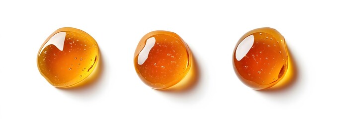 Fototapeta premium Three Drops of Honey on a White Background.