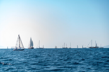Sailing ship yachts with sails. Sailboat in the Sea over mountains background. Sailing boats...