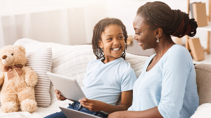 Cheerful Afro Family Browsing Internet, Mom And Daughter Searching For Information. Copy space
