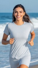 Fototapeta premium A smiling beautiful hispanic woman jogging on the beach, ocean waves and running on beach for health and exercise in background 